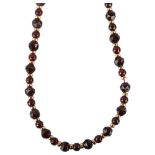 A 14ct gold garnet spacer necklace, necklace length 44cm, 33.7g A few garnets have large surface