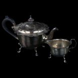A George V silver 2-piece bachelor's tea set, comprising teapot and cream jug, circular-shaped