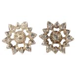 A pair of Antique diamond starburst earrings, unmarked white metal closed-back settings with rose-