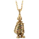 A novelty 9ct gold gem set figural articulated clown pendant necklace, on 9ct cable link chain,
