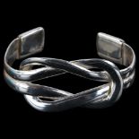 A heavy handmade silver interlocking torque bangle, by C Wilkes, band width 28.5mm, internal