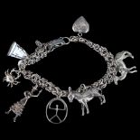 A Continental silver fancy link charm bracelet with various silver charms, bracelet length 16cm,