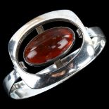 EINER FEHRN - a Danish modernist sterling silver and amber openwork torque bangle, setting height