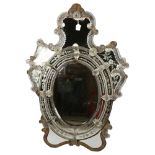 A Venetian wall mirror with elaborate moulded flowerhead mounts and etched panels, overall height