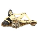 A cold painted bronze reclining erotic figure on a tiger skin rug, in the manner of Bergmann, length