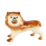 A large Staffordshire pottery lion, length 33cm