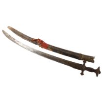 An 18th/19th century Indian Talwar in leather bound wooden scabbard, length 97cm Hilt rocks slightly