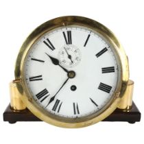 An Antique brass ship's bulkhead clock, white enamel dial with Roman numeral hour markers and