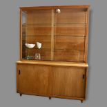 A mid-century oak library display / bookcase, with glass shelving and sides to top, and cupboard