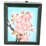 A green leather-bound jewel box, with floral enamel inset panel, 22cm x 19cm Leather is worn at