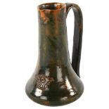 Redhill Art Guild Arts and Crafts lead glaze red earthenware jug with impressed motifs, height 15.