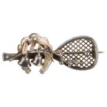 A 19th century silver tennis racket brooch, with applied lobed horseshoe and bells, indistinct