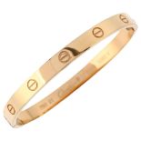 CARTIER - a modern 18ct gold 'LOVE' bangle, with screwhead motifs, signed Cartier, serial no.