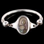 A Continental stone set glass torque bangle, unmarked silver settings, panel length 31.9mm, internal