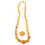 A single-strand graduated butterscotch amber bead necklace, beads ranging from 25.1mm - 9.2mm,