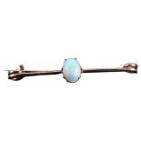 An early 20th century 9ct gold opal bar brooch, prong set with oval cabochon opal measures: 7.14mm x