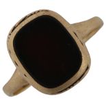 A 9ct gold onyx panel signet ring, setting height 11mm, size G, 1.6g Ring is quite heavily worn,
