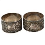 A pair of Chinese export silver napkin rings, circa 1900, relief embossed ceremonial decoration,