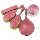 An Art Deco George V silver and pink enamel 5-piece dressing table set, comprising hand mirror, pair