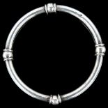 A Mexican sterling silver slave bangle, stamped Taxco, band width 5.2mm, internal circumference