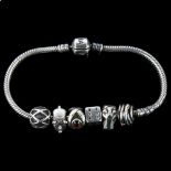 PANDORA - a sterling silver snake link charm bracelet, with 6 silver charms, bracelet length 18cm,