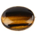 A tigers eye brooch, in unmarked yellow metal frame, brooch length 33.2mm, 7.7g No damage or
