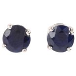 A pair of solitaire sapphire earrings, unmarked white gold settings with stud fittings, sapphire