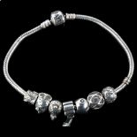 PANDORA - a sterling silver snake link charm bracelet, with 7 silver charms, bracelet length 20cm,