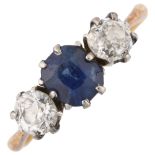 An 18ct gold three stone sapphire and diamond ring set with oval mixed-cut sapphire and old