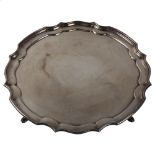 ASPREY - an Elizabeth II silver salver, circular scalloped form with hoof feet, by Asprey & Co,