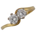 An 18ct gold two stone diamond crossover ring, set with modern round brilliant-cut diamonds, total