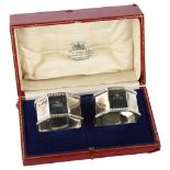 A pair of George V silver octagonal napkin rings, with dragooned borders, by George Unite & Sons,