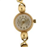 LANE CRAWFORD - a lady's 18ct gold mechanical bracelet watch, silvered dial with gilt block hour