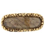 A 19th century mourning brooch, unmarked gold closed-back settings with woven hair panel beneath