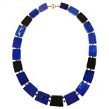 A lapis lazuli and black fossil marble tablet necklace, with 14ct gold barrel clasp, necklace length