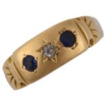 An early 20th century 18ct gold three stone sapphire and diamond ring, setting height 6.4mm, size N,