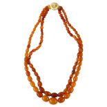 A double-strand butterscotch amber bead necklace, beads ranging from 15.8mm - 7.7mm, necklace length