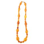 A single-strand butterscotch amber bead necklace, beads ranging from 21.4mm - 9.2mm, necklace length