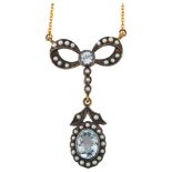 A modern blue topaz and seed pearl ribbon bow pendant necklace, in Edwardian style, unmarked gold