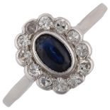 An 18ct white gold sapphire and diamond cluster ring, set with oval mixed-cut sapphire and single-