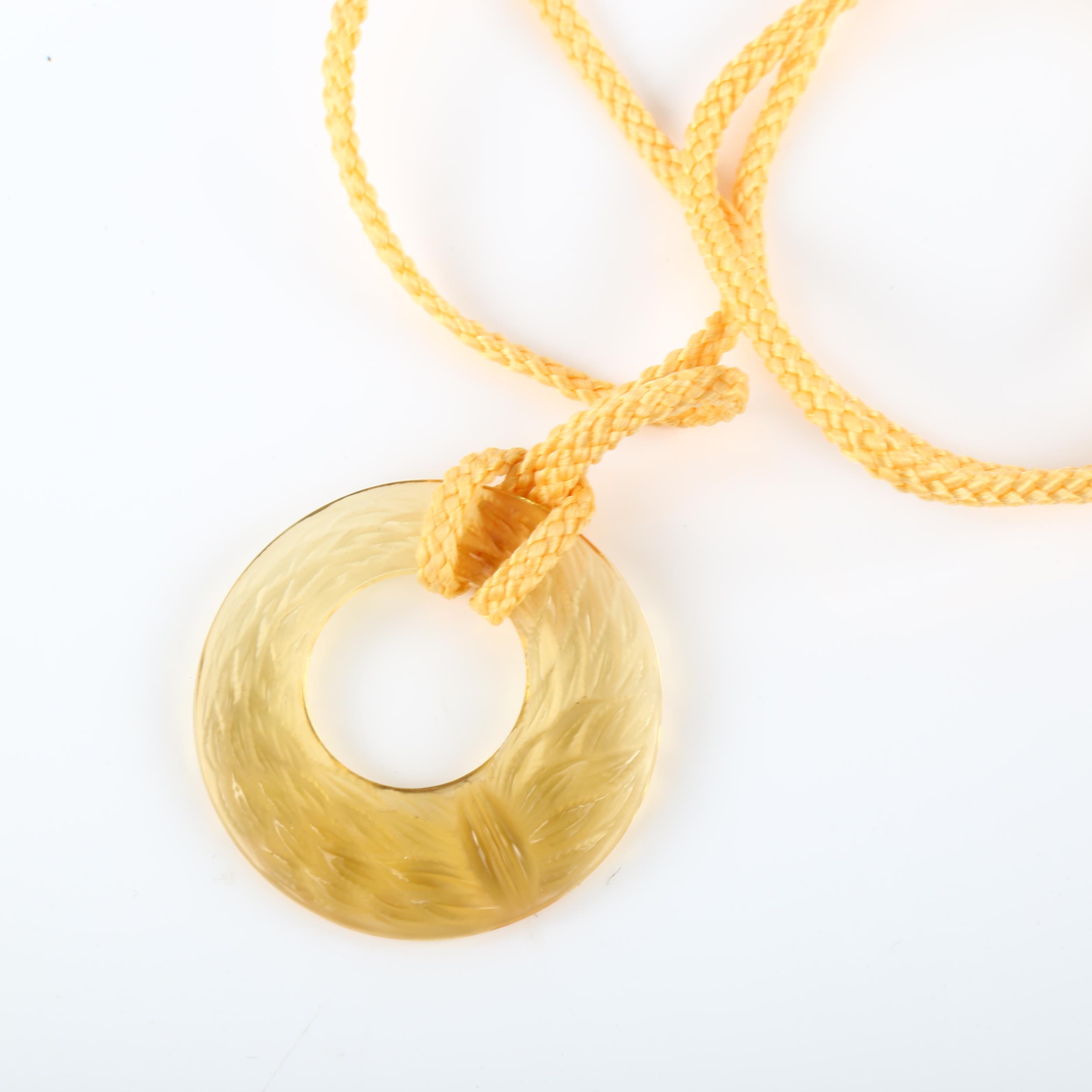 LALIQUE - an amber glass laurel wreath disc pendant, signed Lalique France, diameter 44.1mm, 14. - Image 5 of 6