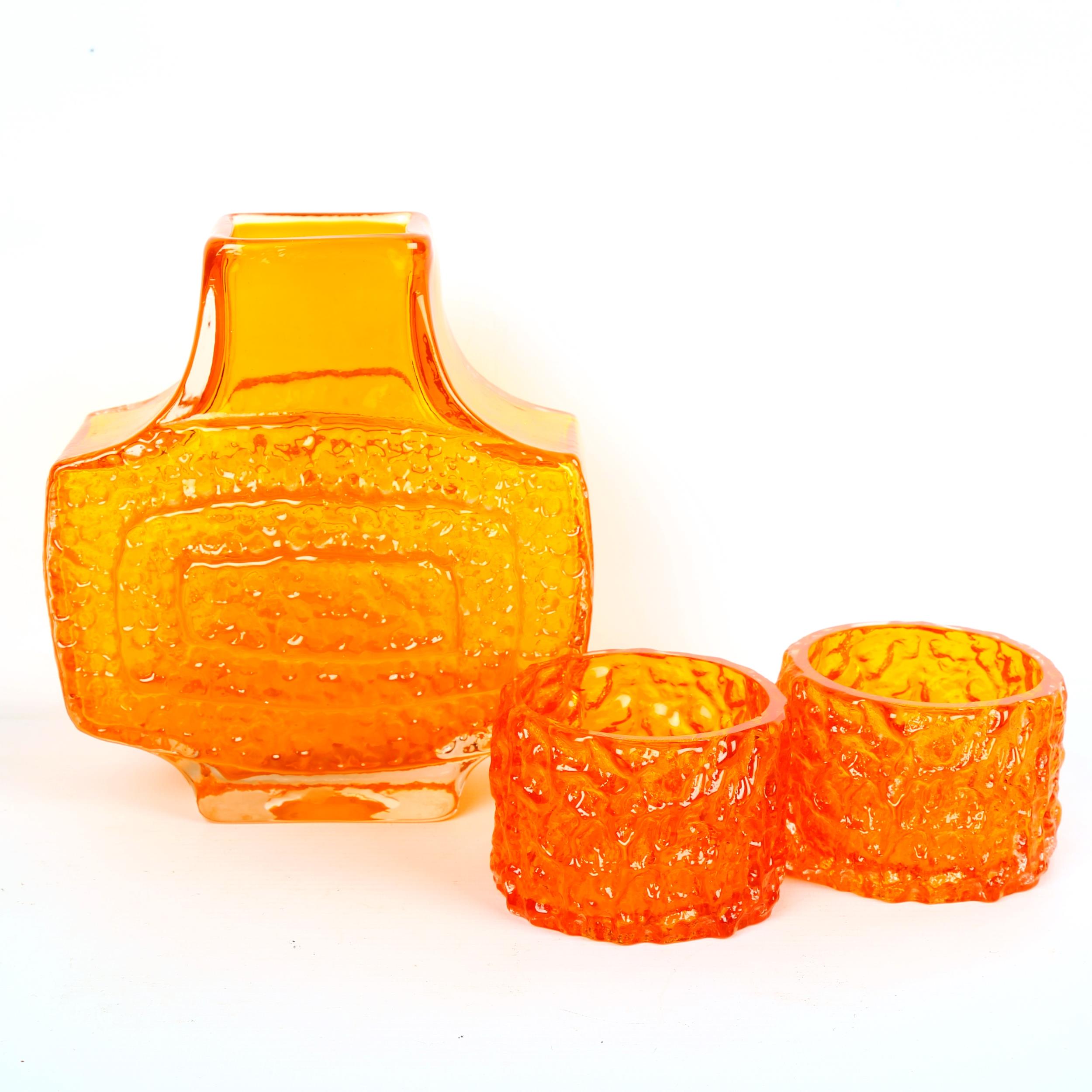 GEOFFREY BAXTER for Whitefriars Glass, a Tangerine TV textured vase and two Tangerine candle