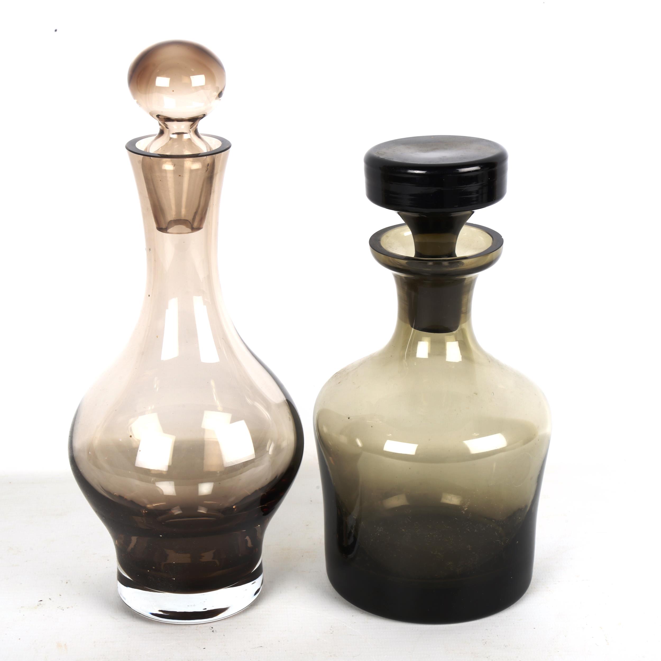 2 mid-century smoked glass decanters, tallest 28cm smallest decanter has several chips to rim and