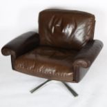 A 1970s' DE SEDE DS 31 lounge swivel chair, in brown leather, with aluminium base, height 75cm