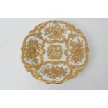 Meissen gilded and moulded dish, decorated with foliate panels within Rococo style moulded scroll