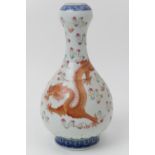 Chinese bottle vase, 20th Century, decorated with a dragon flying amidst clouds with a phoenix, in