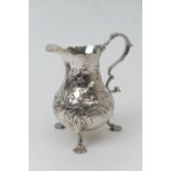 Early George III silver baluster cream jug, maker 'IW', London 1765, decorated with fowl feeding