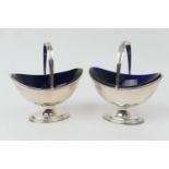 Pair of George V silver sugar baskets, Chester 1929, each of boat shape with reeded swing handle and