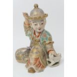 Japanese Satsuma model of a boy, Meiji (1868-1912), seated with his pet dog, decorated throughout