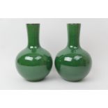 Pair of Chinese apple green glazed bottle vases, late 19th Century, each with a bulbous body and